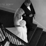 A bride descends the stairwell at Duke Mansion