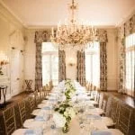 Social Dining Room with white and blue accents and a hanging chandelier
